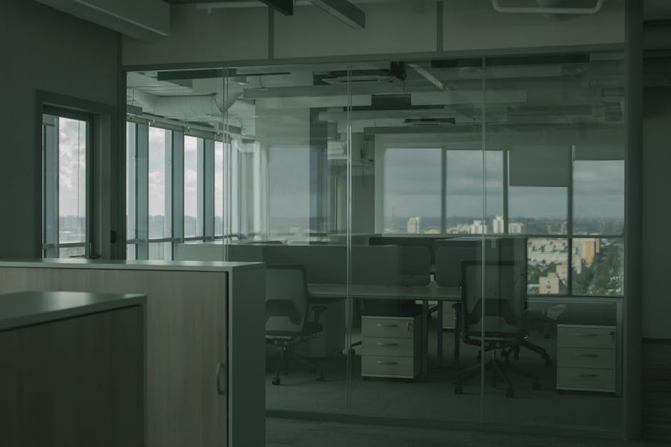 Spacious empty office with glass walls and city views